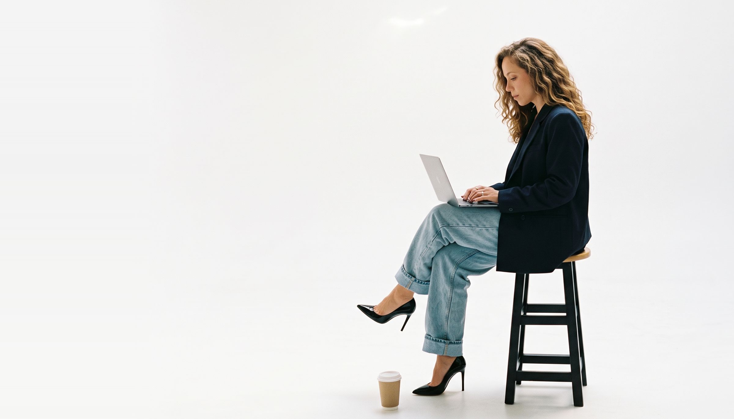 Bethania at her desk, laughing, laptop open